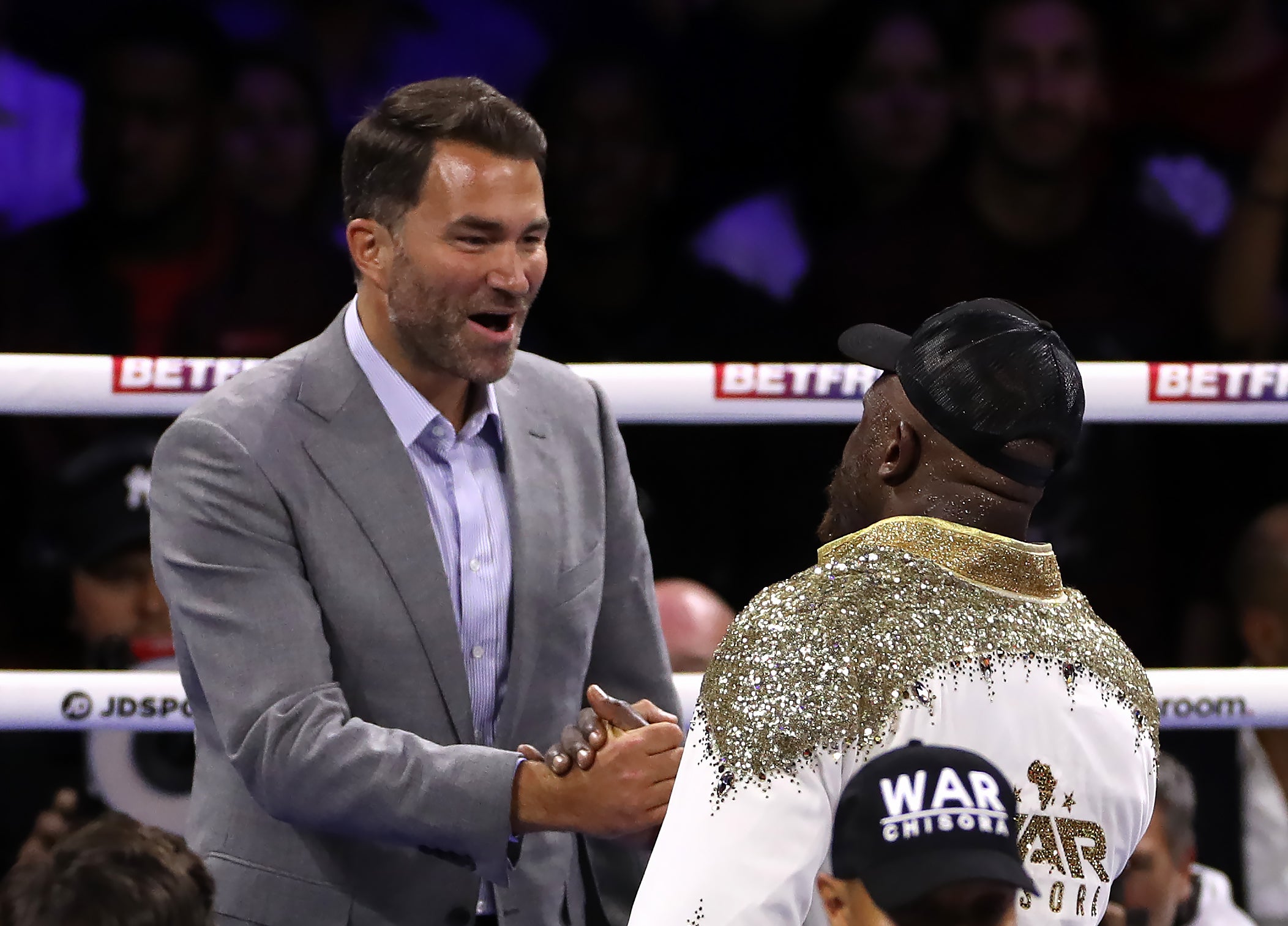 Chisora is congratulated by promoter Eddie Hearn (Bradley Collyer/PA)