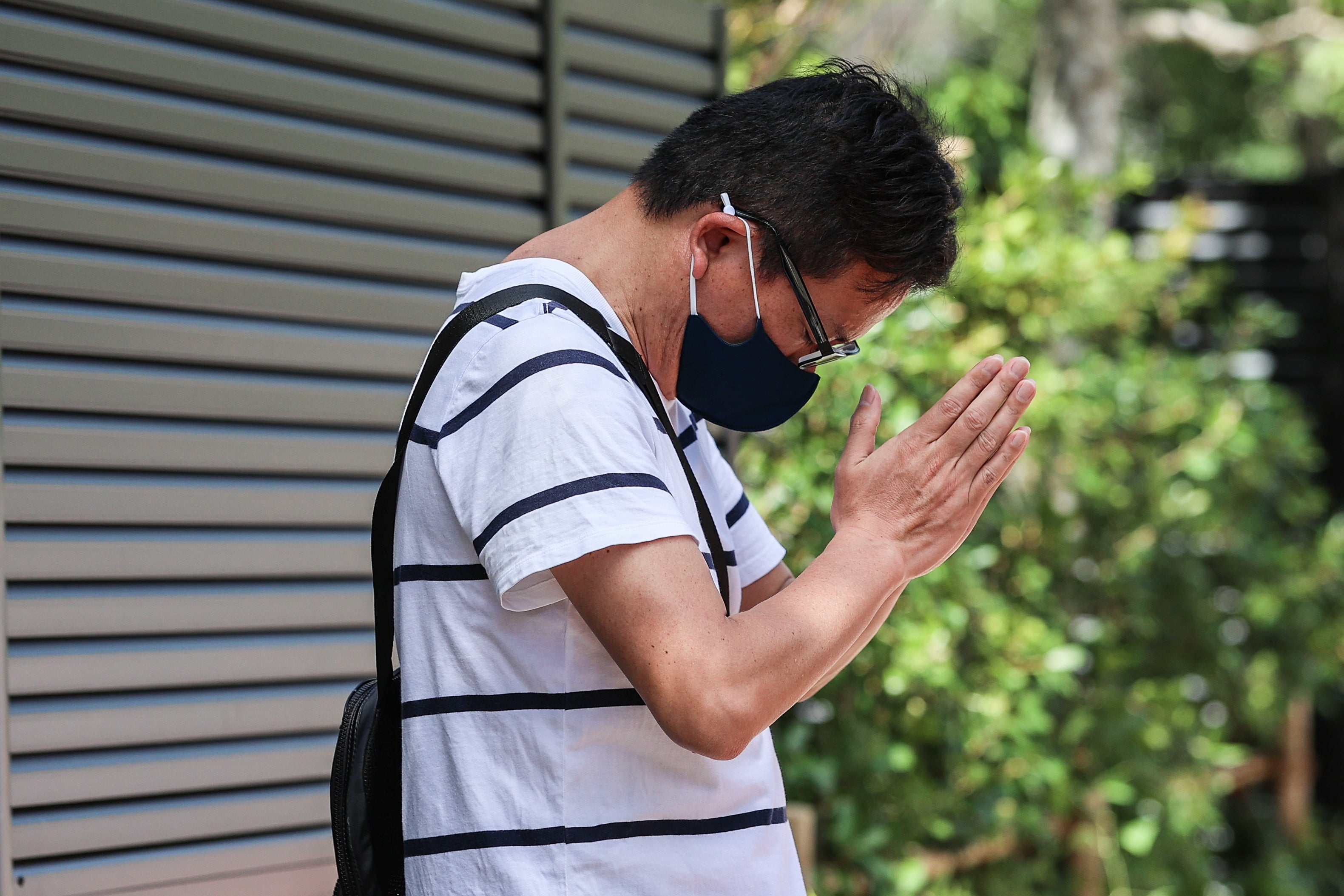 A man prays in front of former Japanese Prime Minister Shinzo Abe's residence