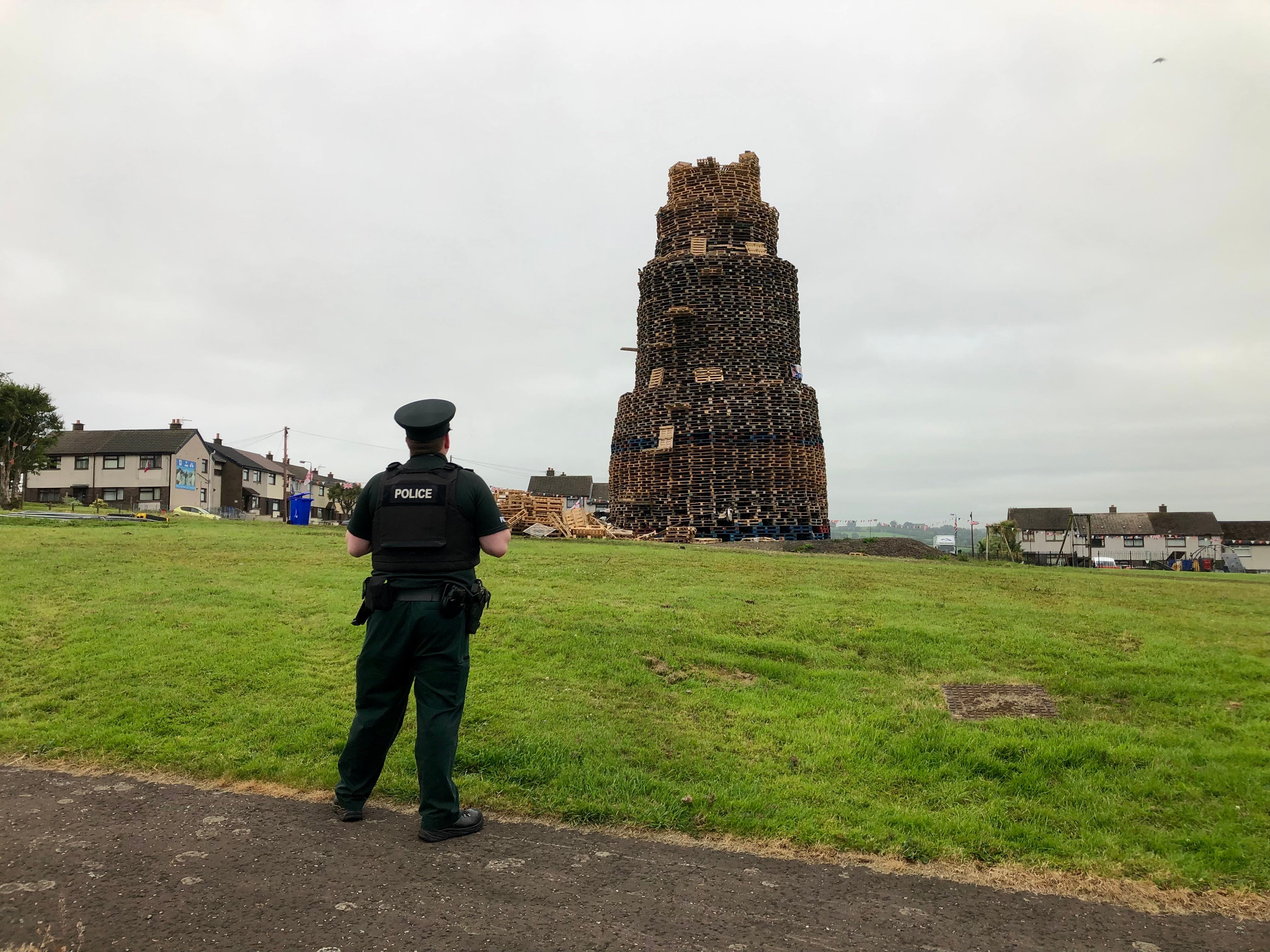 Police at the scene of the fatal fall at the Antiville bonfire in Larne, Co Antrim (PA)