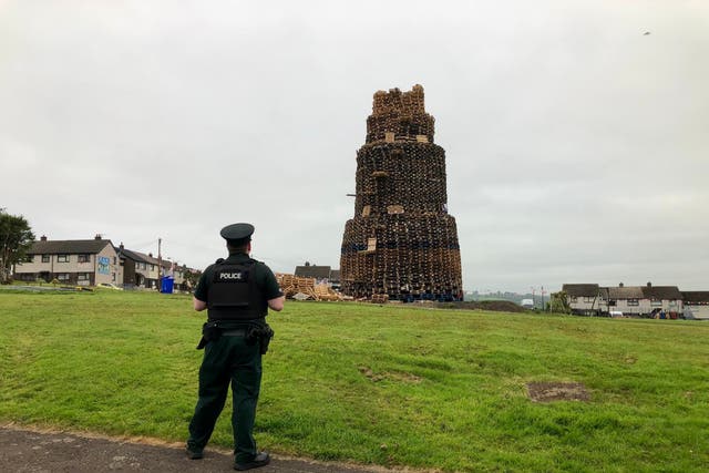 Police at the scene of the fatal fall at the Antiville bonfire in Larne, Co Antrim (PA)