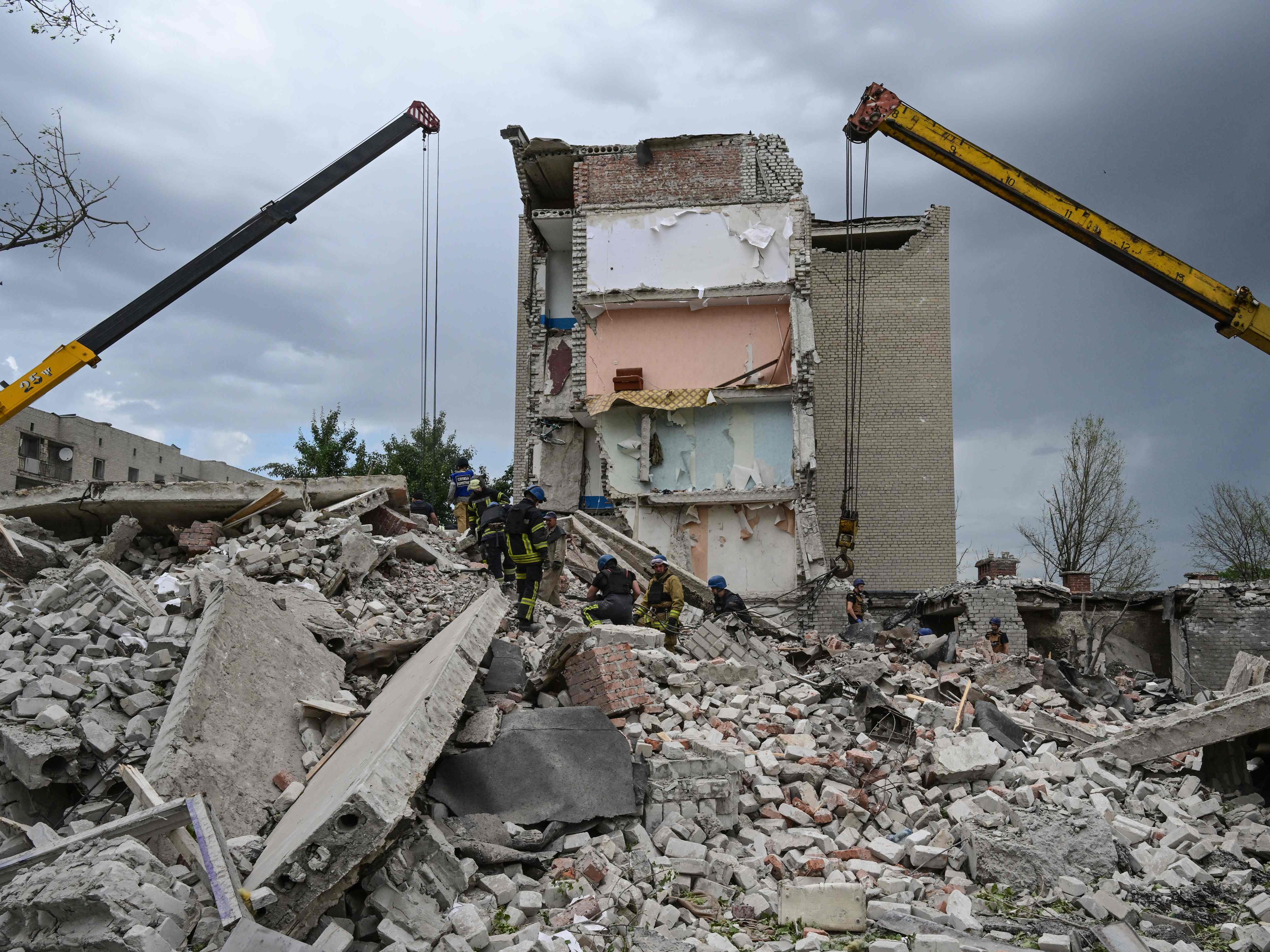Rescuers clear the scene after a building was partially destroyed in an attack by Russian missiles in Chasiv Yar, in the Donetsk region of Ukraine