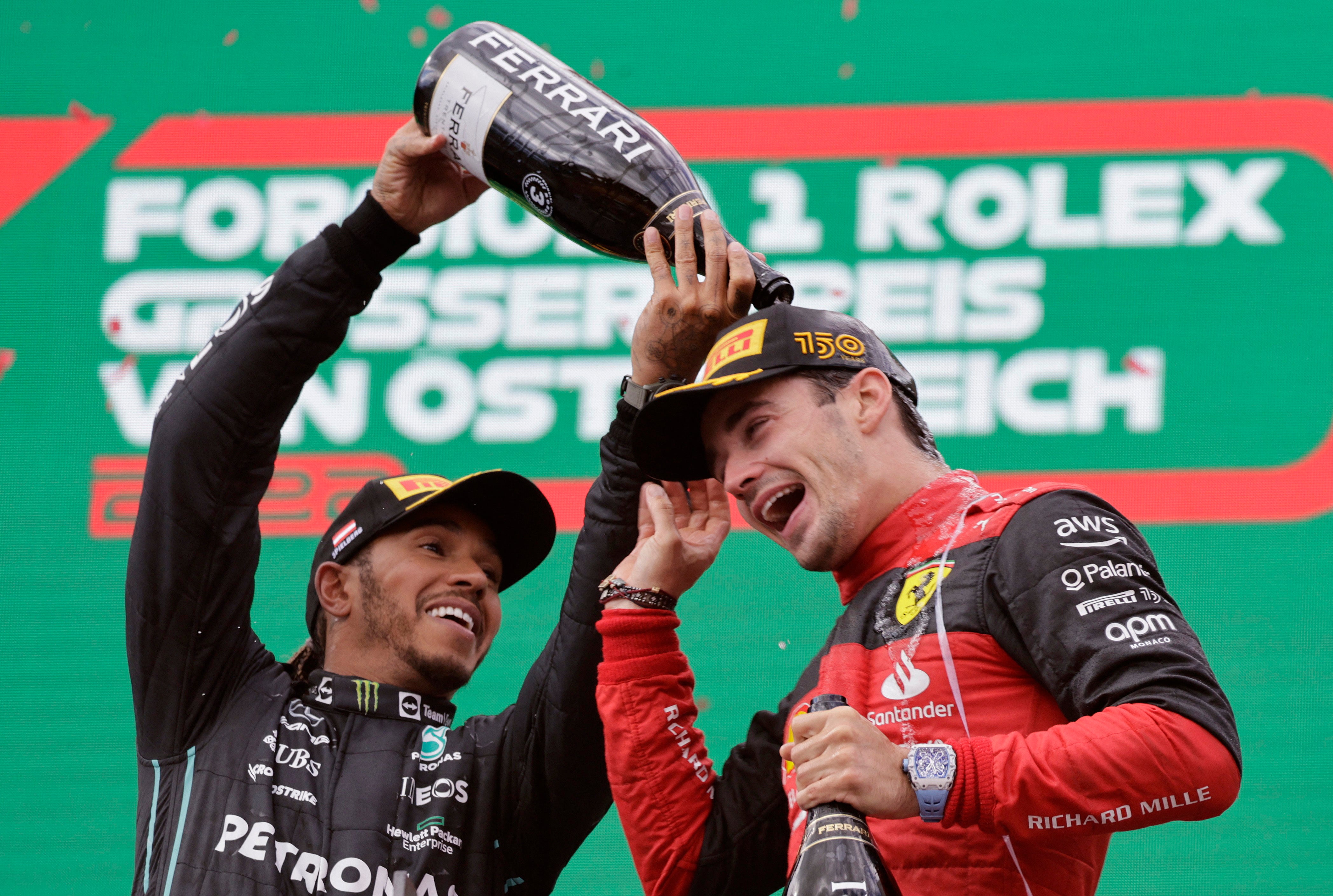 Ferrari’s Charles Leclerc celebrates on the podium with Mercedes’ Lewis Hamilton after the Austrian Grand Prix