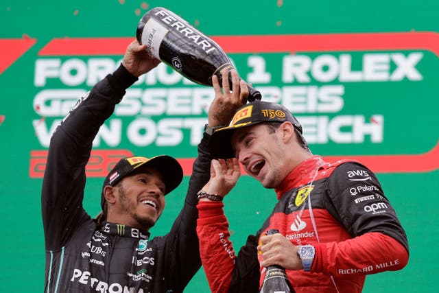 <p>Ferrari’s Charles Leclerc celebrates on the podium with Mercedes’ Lewis Hamilton after the Austrian Grand Prix </p>