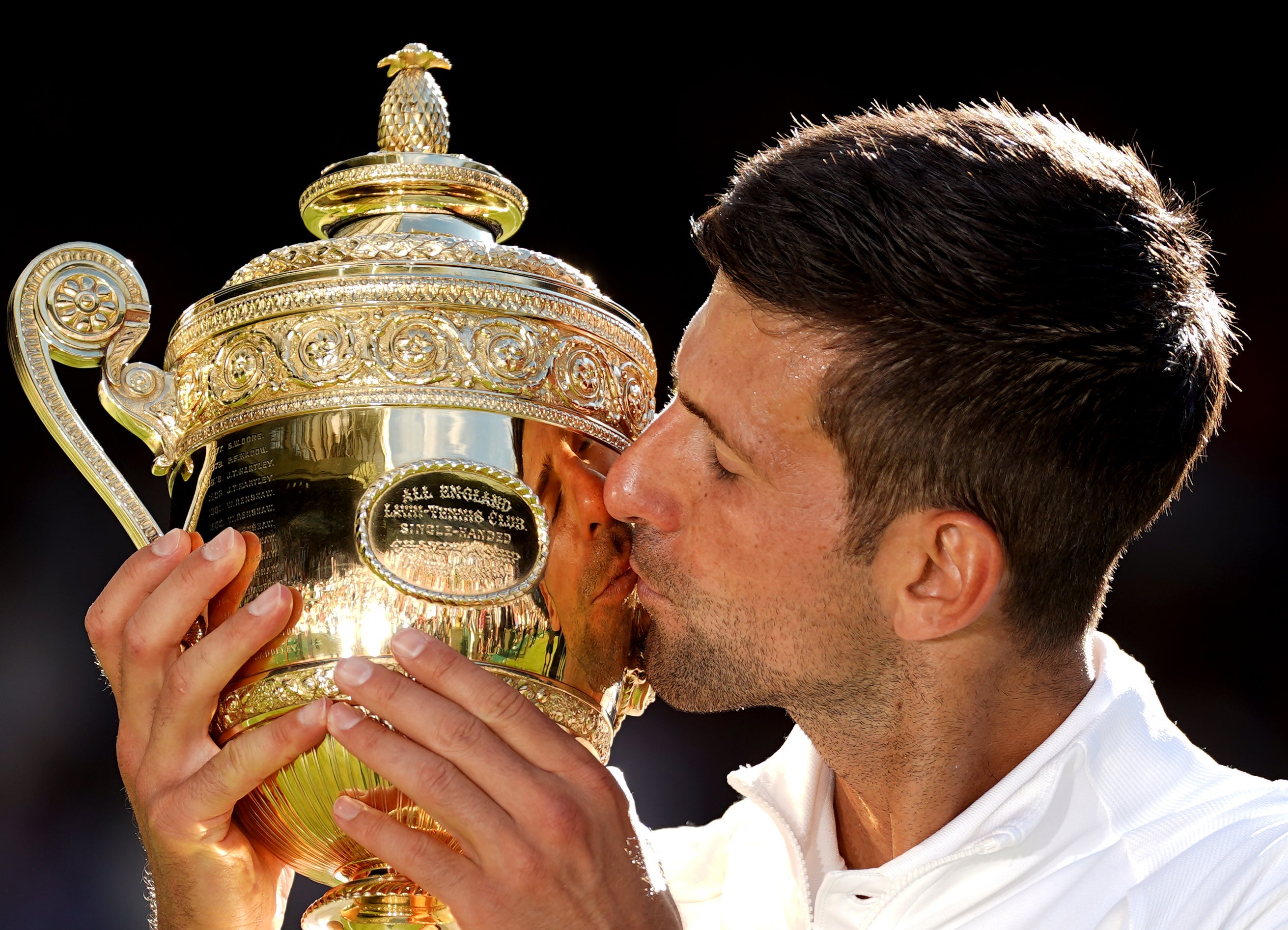 Sealed with a kiss: Novak Djokovic lifts the Wimbledon trophy for a seventh time (Adam Davy/PA)