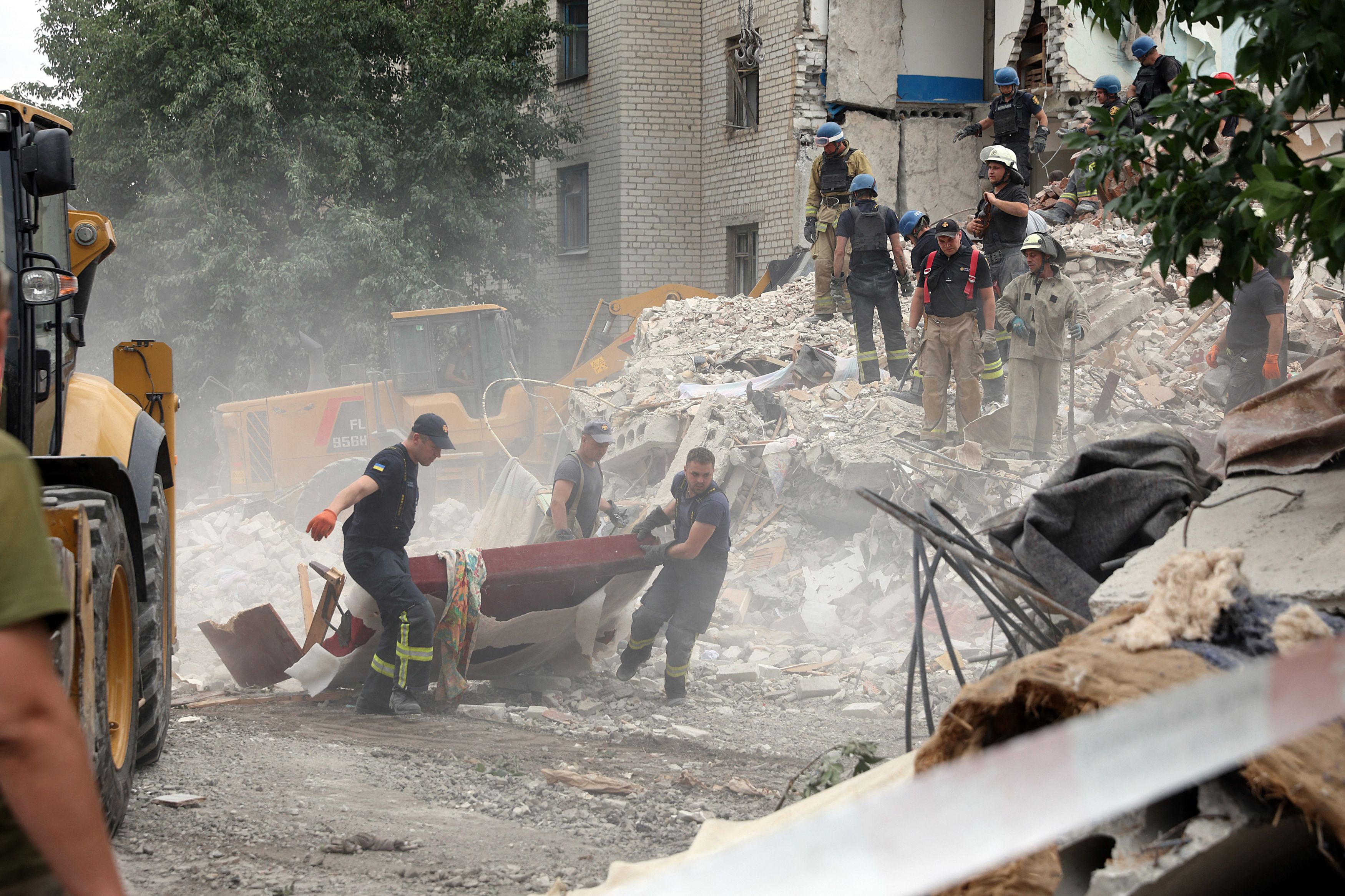 Rescuers clear the scene on Sunday after shelling in the eastern town of Chasiv Yar