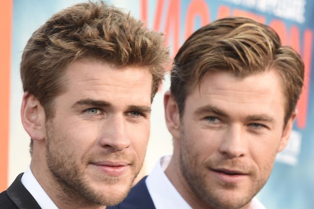 <p>Actors Liam Hemsworth (L) and Chris Hemsworth arrive for the premiere of Warner Bros' "Vacation" at the Regency Village Theatre in Los Angeles on July 27, 2015. AFP PHOTO/ROBYN BECK (Photo credit should read ROBYN BECK/AFP via Getty Images)</p>