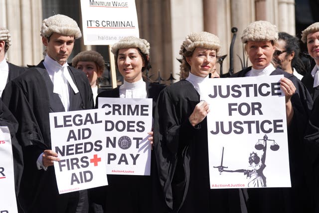 Criminal defence barristers gather outside the Royal Courts of Justice in London to support the ongoing Criminal Bar Association action over Government set fees for legal aid advocacy work (Kirsty O’Connor/PA)