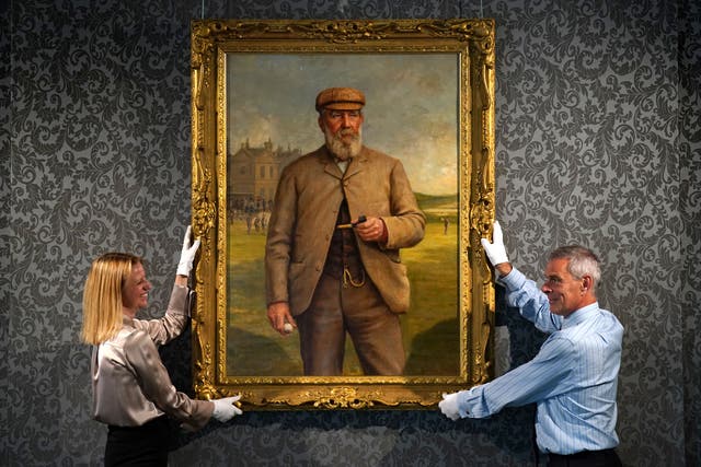 May Matthews and Charles Graham-Campbell from Bonhams with a ‘Portrait of Tom Morris Senior’ by Henry Brooks (Andrew Milligan/PA)