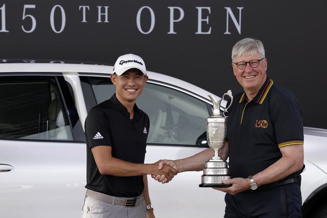 Collin Morikawa (left) returns the Claret Jug to R&A chief executive Martin Slumbers, ahead of The 150th Open Championship (Richard Sellers/PA)