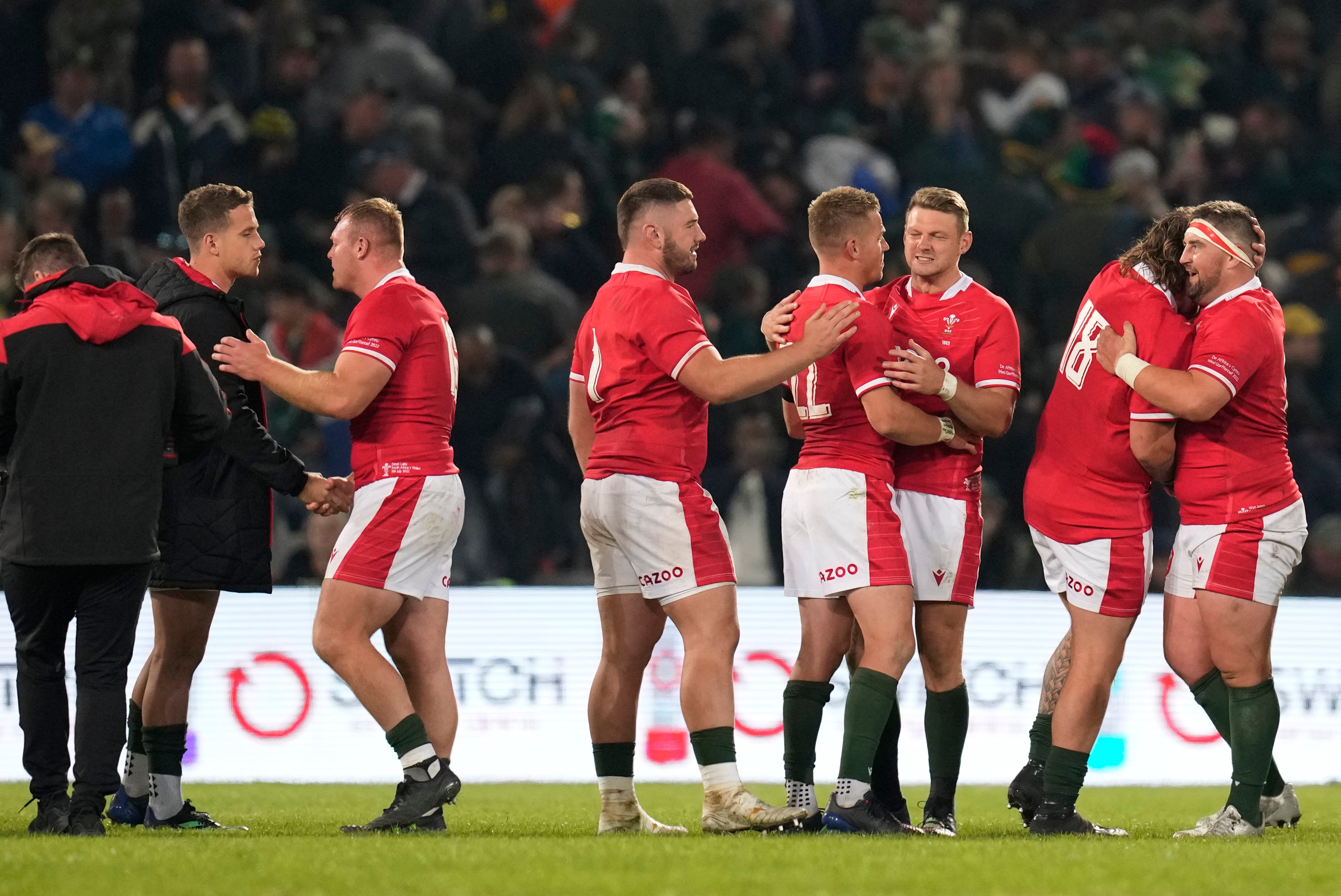 Wales players celebrate after beating South Africa in Bloemfontein (Themba Hadebe/AP)