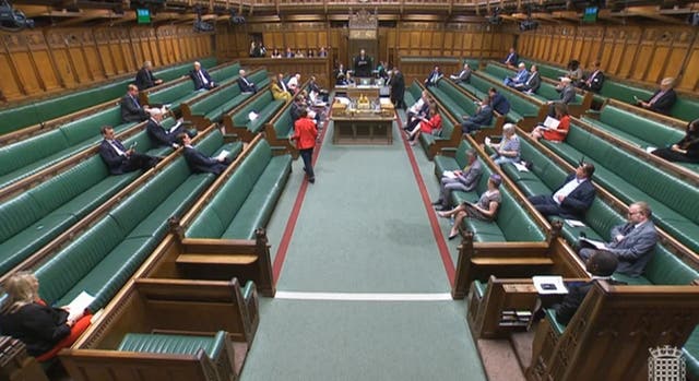 Wet patches are seen on the carpet of the chamber of the House of Commons, London, after the sitting was delayed for 60 minutes as numerous buckets near the green benches were catching drips raining in through the ceiling on Monday afternoon. Picture date: Monday July 11, 2022 (House of Commons/PA)
