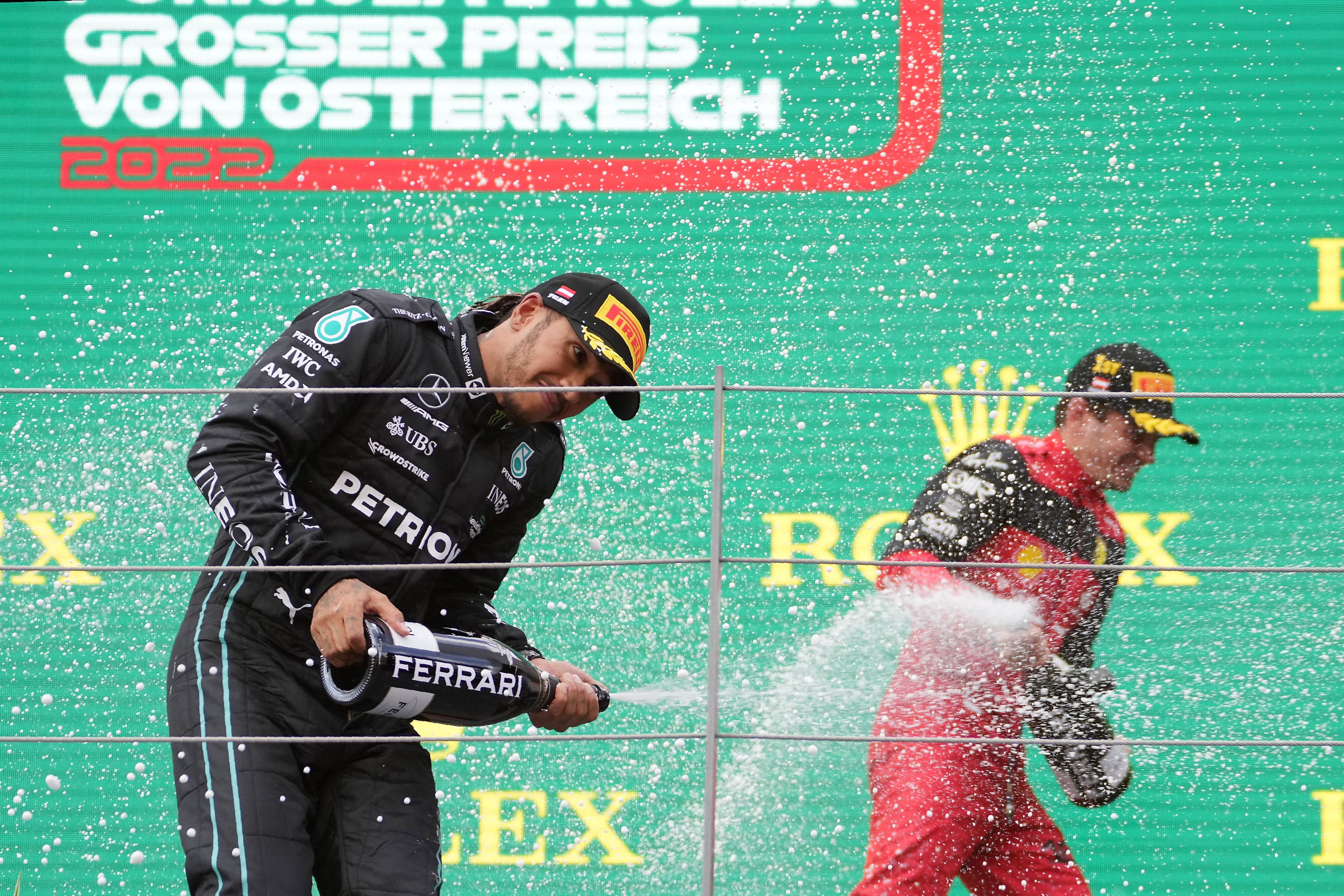 Lewis Hamilton celebrates his third podium finish in as many races (Matthias Schrader/AP)