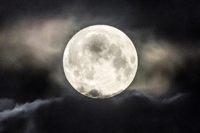 File image dated: Tuesday June 14, 2022, which shows the strawberry supermoon setting behind a cloud above Huddersfield in Yorkshire. Another supermoon is expected on July 13, 2022 (Danny Lawson/PA)