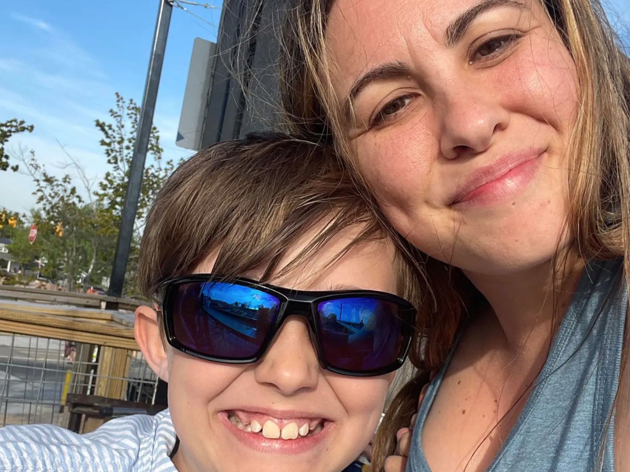 Carson Dunn, 10, with his mother Carly Burgess. Carson died after falling from a play structure in Camp Dearborn, Michigan.
