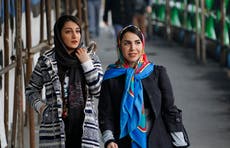 Iranian women removing headscarves to protest mandatory hijab laws 