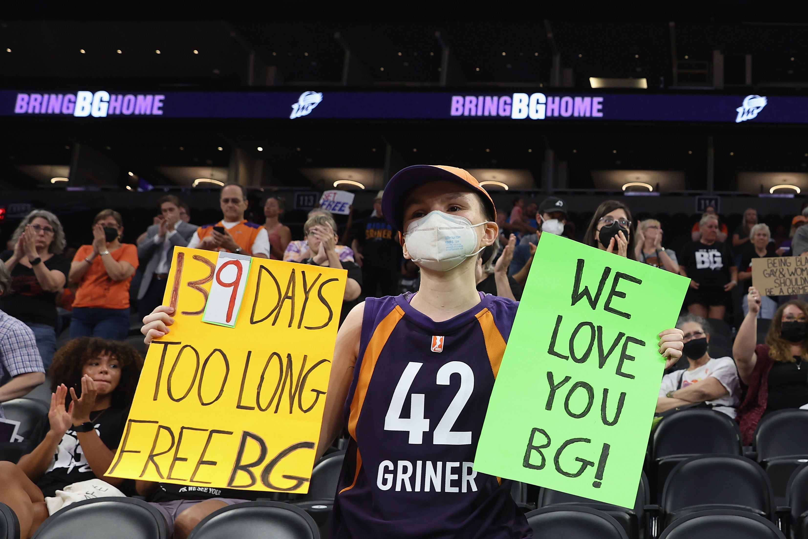 A supporter holds up signs during a rally to support the release of Griner