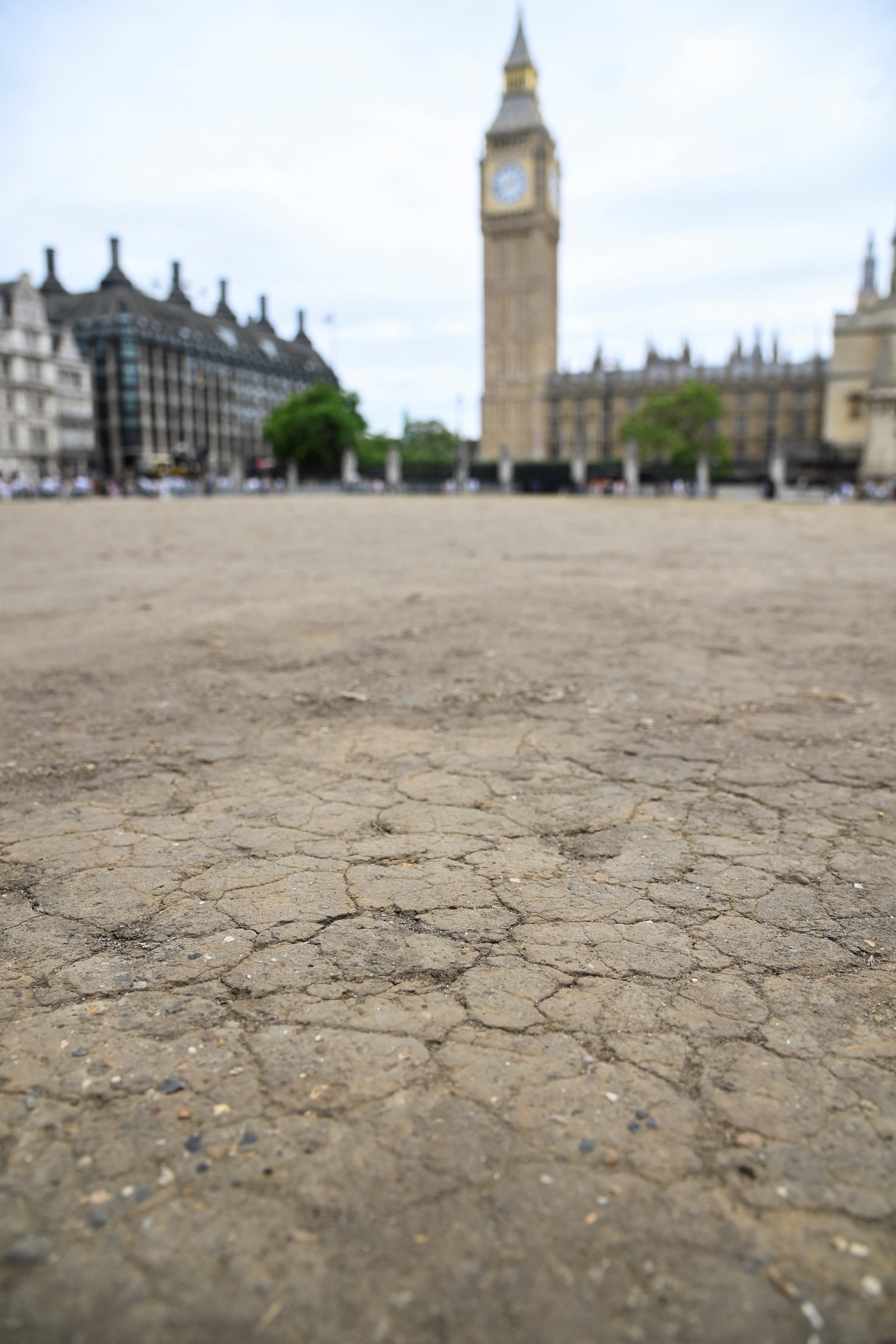 Dry earth cracks in the hot weather in front of the Houses of Parliament on Tuesday