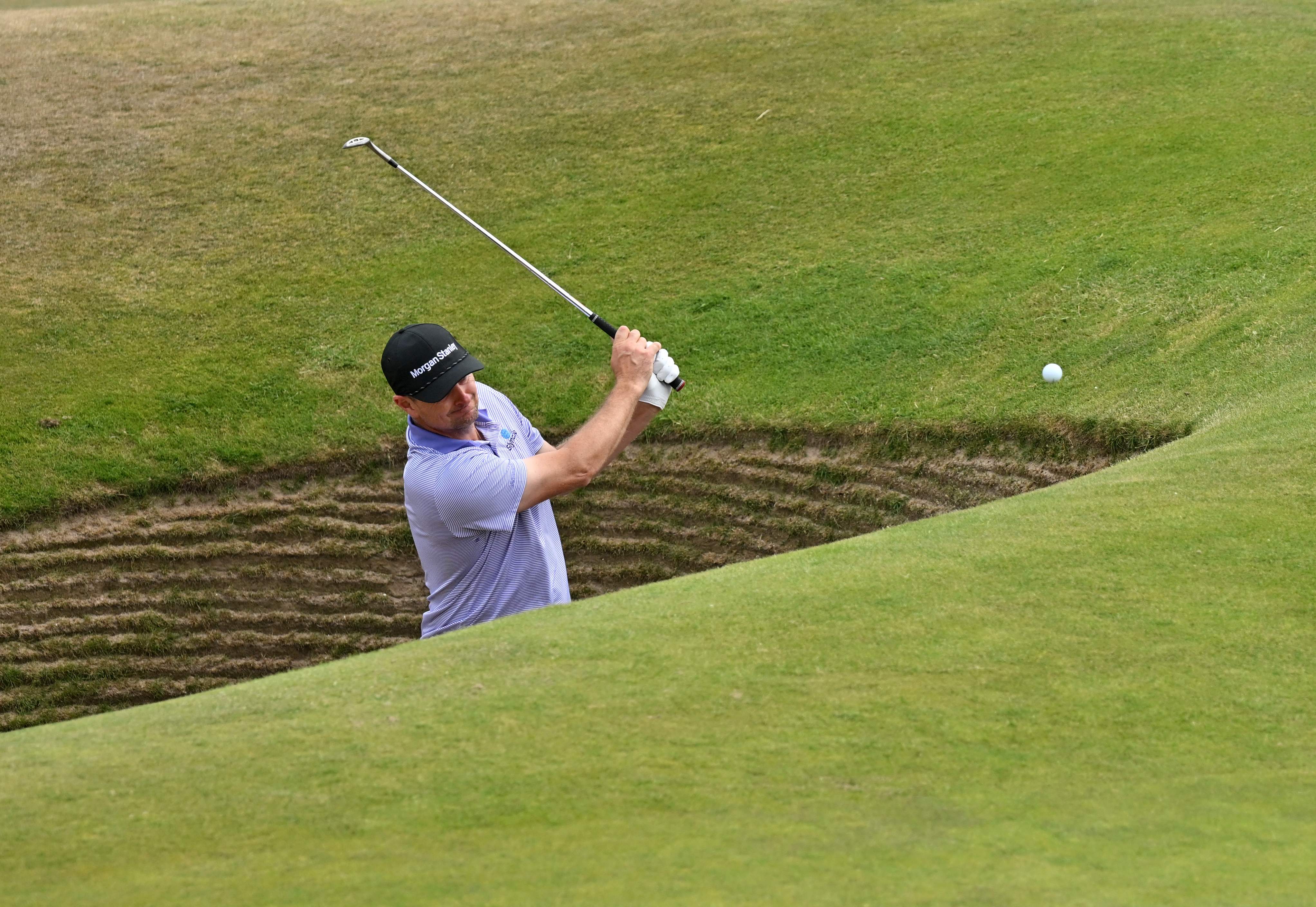 Justin Rose plays out of the road hole bunker