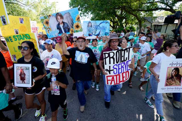 <p>Family and friends of those killed and injured in the school shooting at Robb Elementary take part in a protest march and rally on 10 July</p>