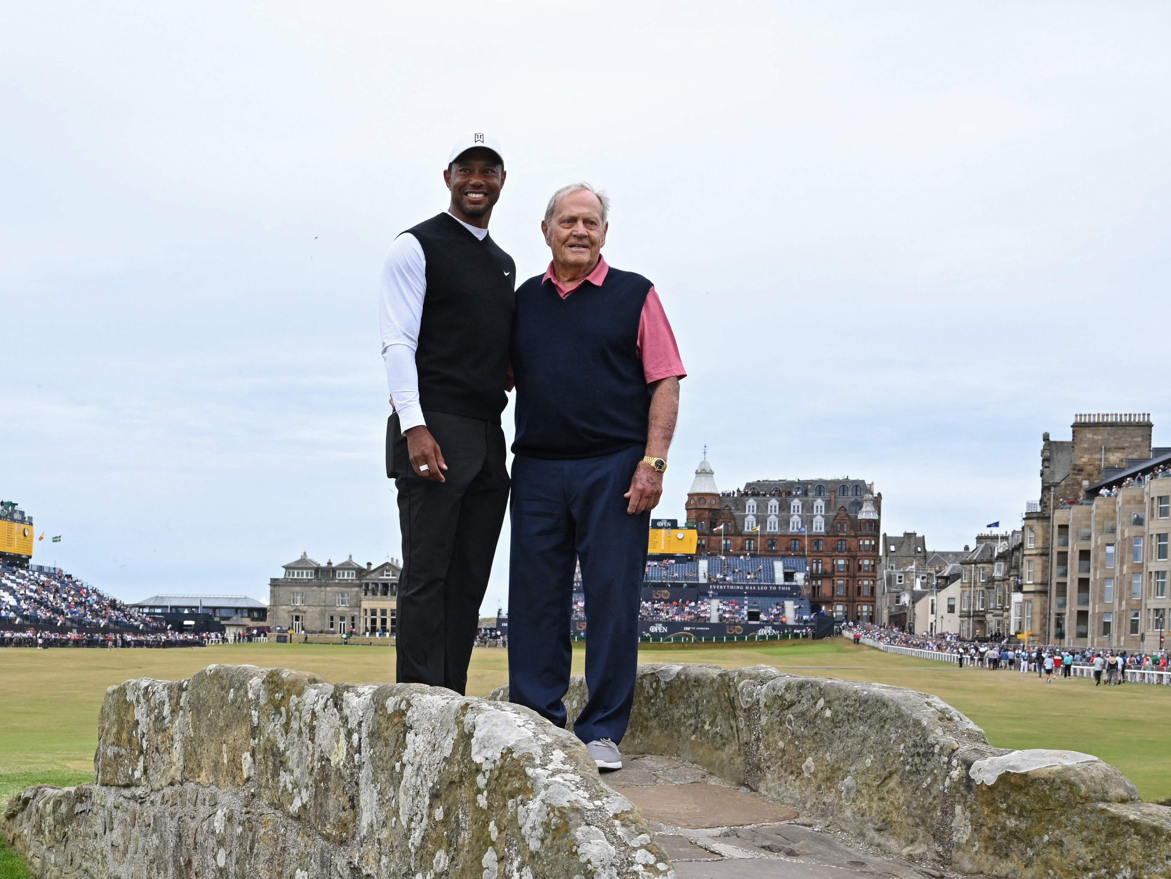 Open winners Woods (left) and Jack Nicklaus on the Swilcan Bridge at the iconic Old Course