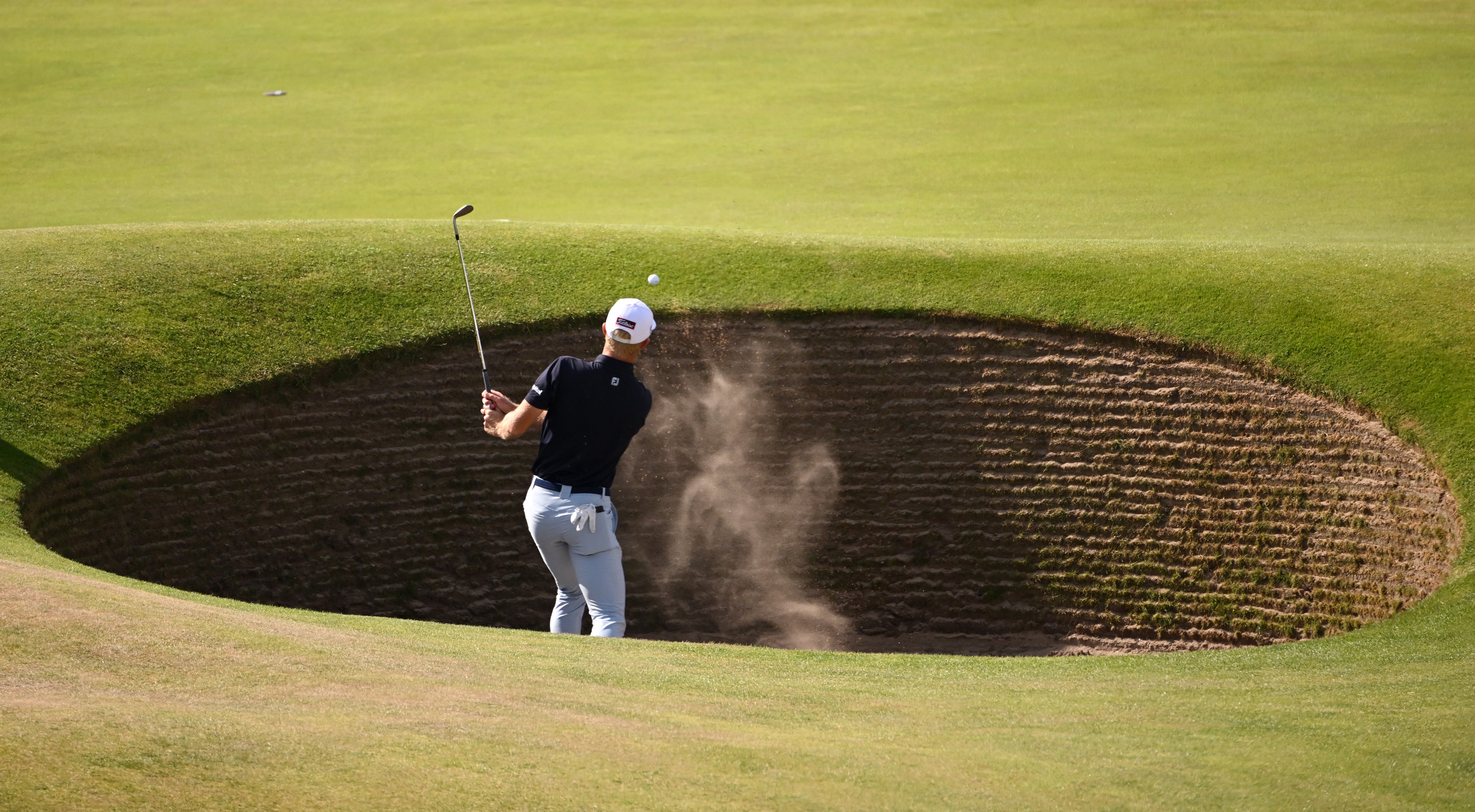 Will Zalatoris plays a shot from the bunker on the 17th