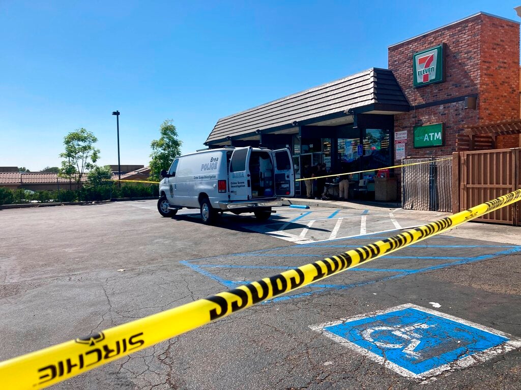 Police investigate a shooting at a 7-Eleven store in Brea, Calif., on Monday, July 11, 2022.