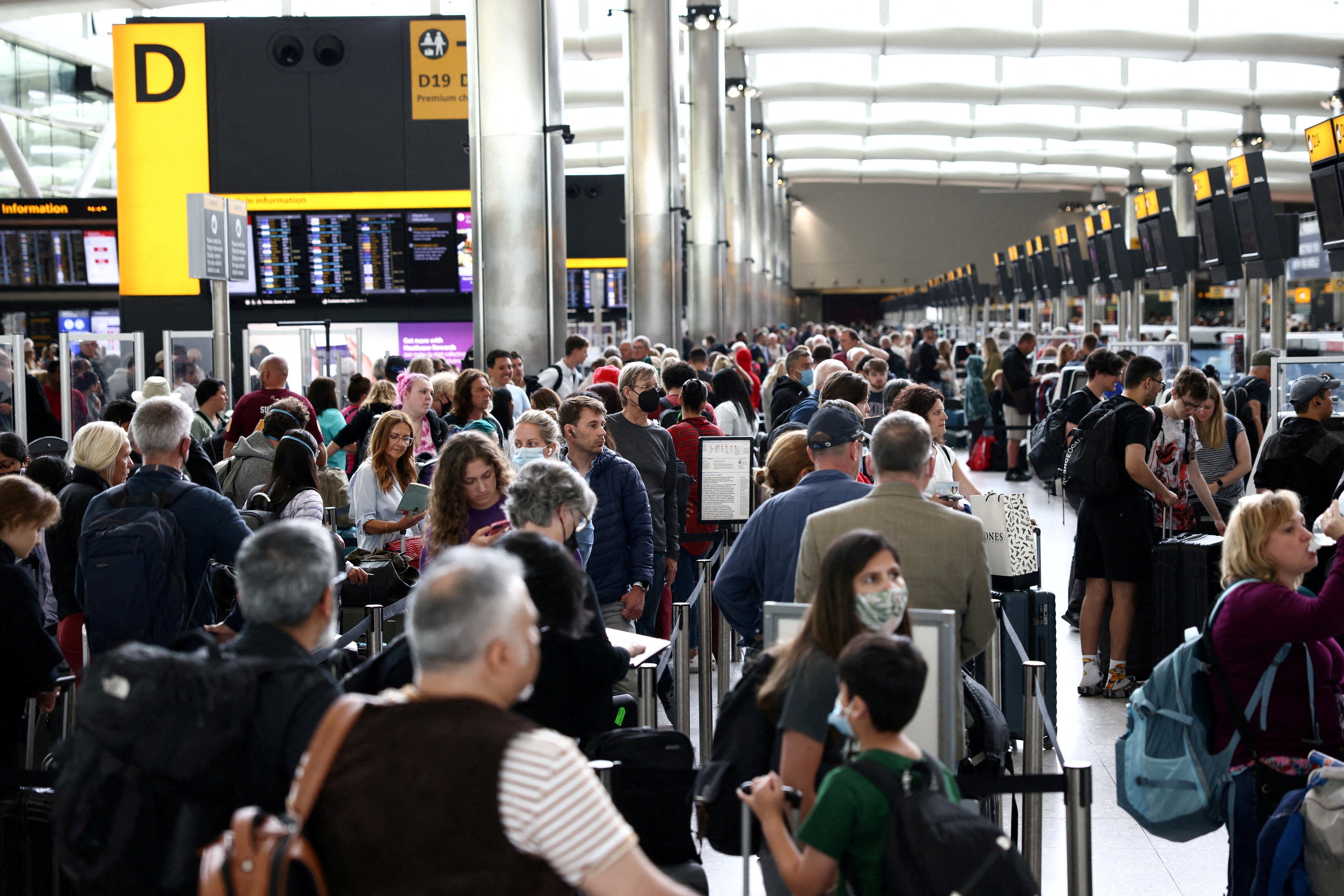 Passengers queue inside the departures terminal of Terminal 2 at Heathrow Airport