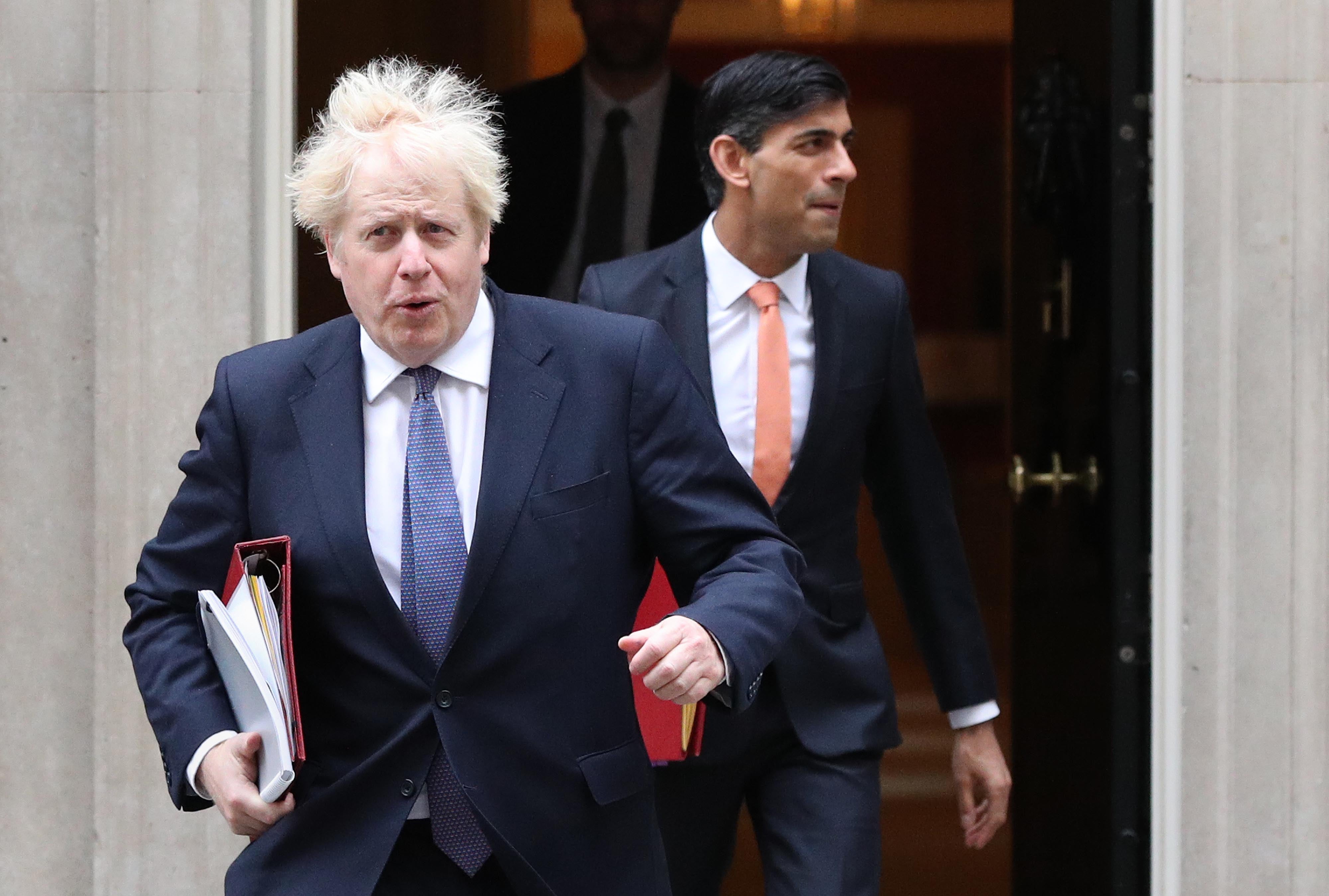 Boris Johnson and Rishi Sunak leaving 10 Downing Street before Mr Sunak quit as chancellor (Jonathan Brady/PA)
