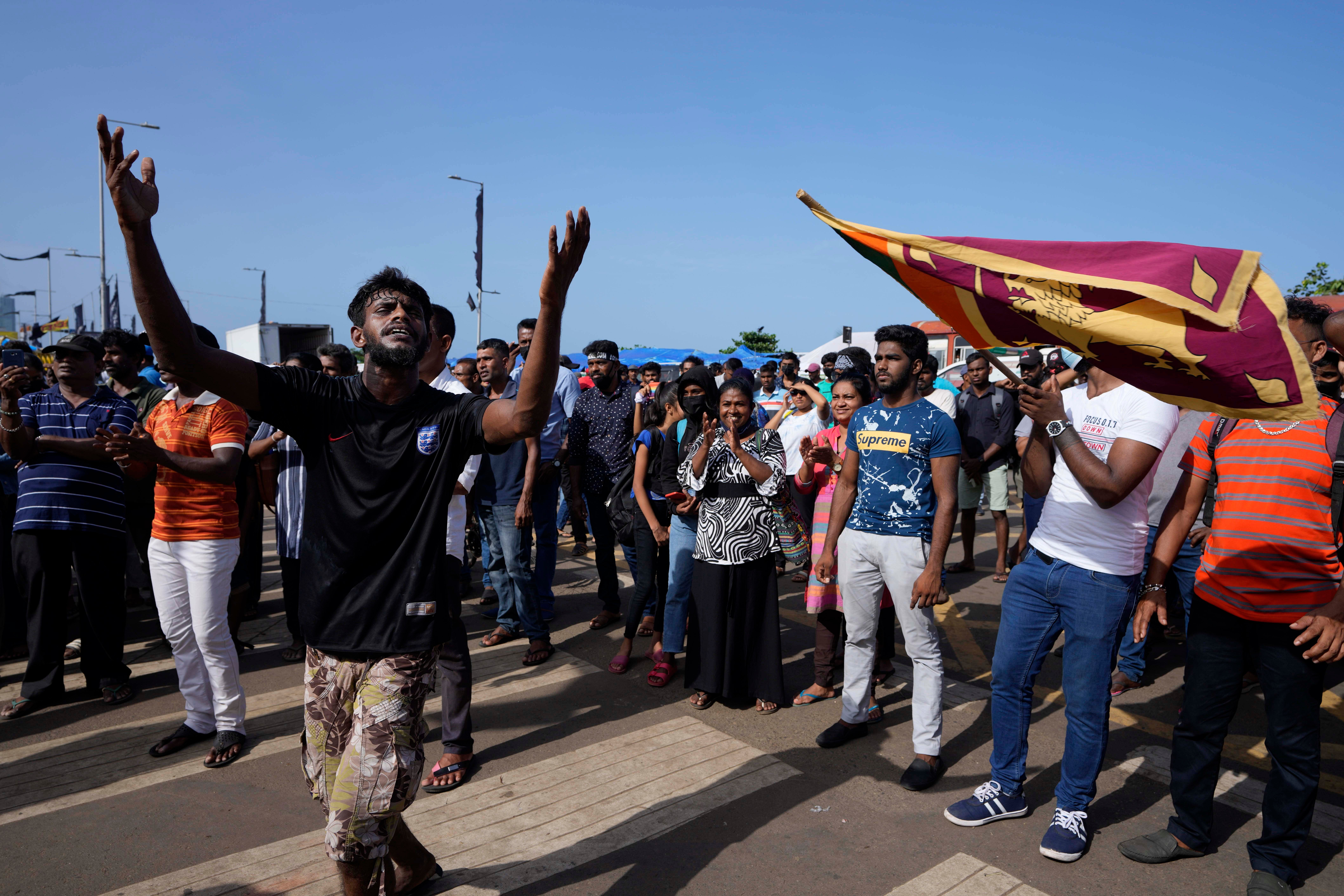Protesters dance shouting slogans against president Gotabaya Rajapaksa outside his office in Colombo