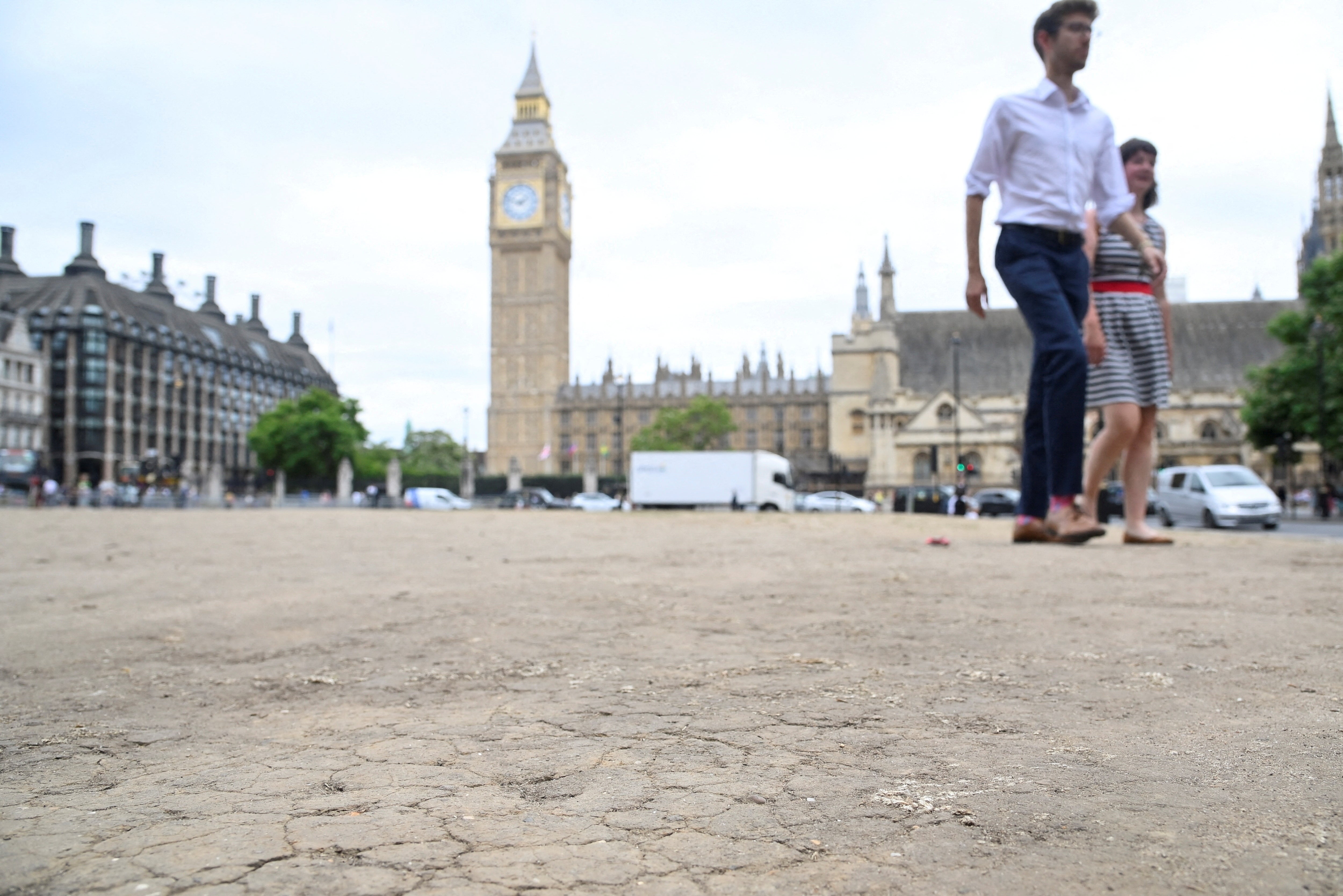 Cracked earth is seen as hot weather continues in Parliament Square