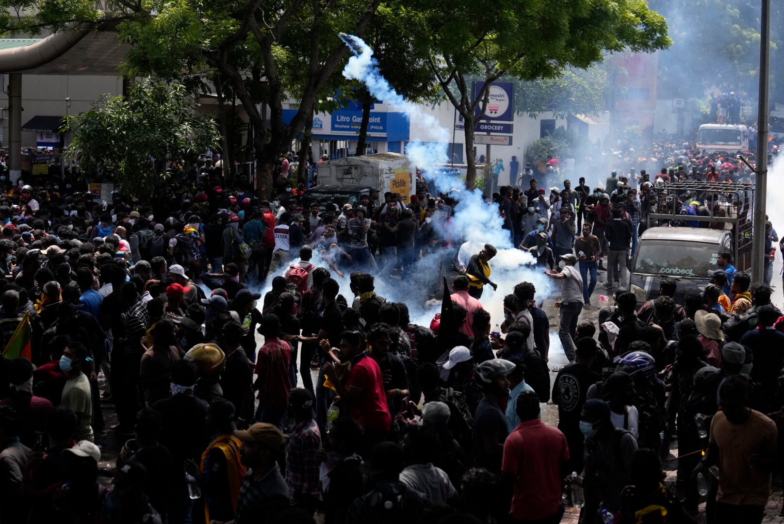 Protestors throw back tear gas shells as they rally outside prime minister Ranil Wickremesinghe’s office