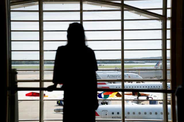 <p>Representative image: A traveler looks out at American Airlines planes at Ronald Reagan Washington National Airport in Arlington, Virginia, on 2 July</p>