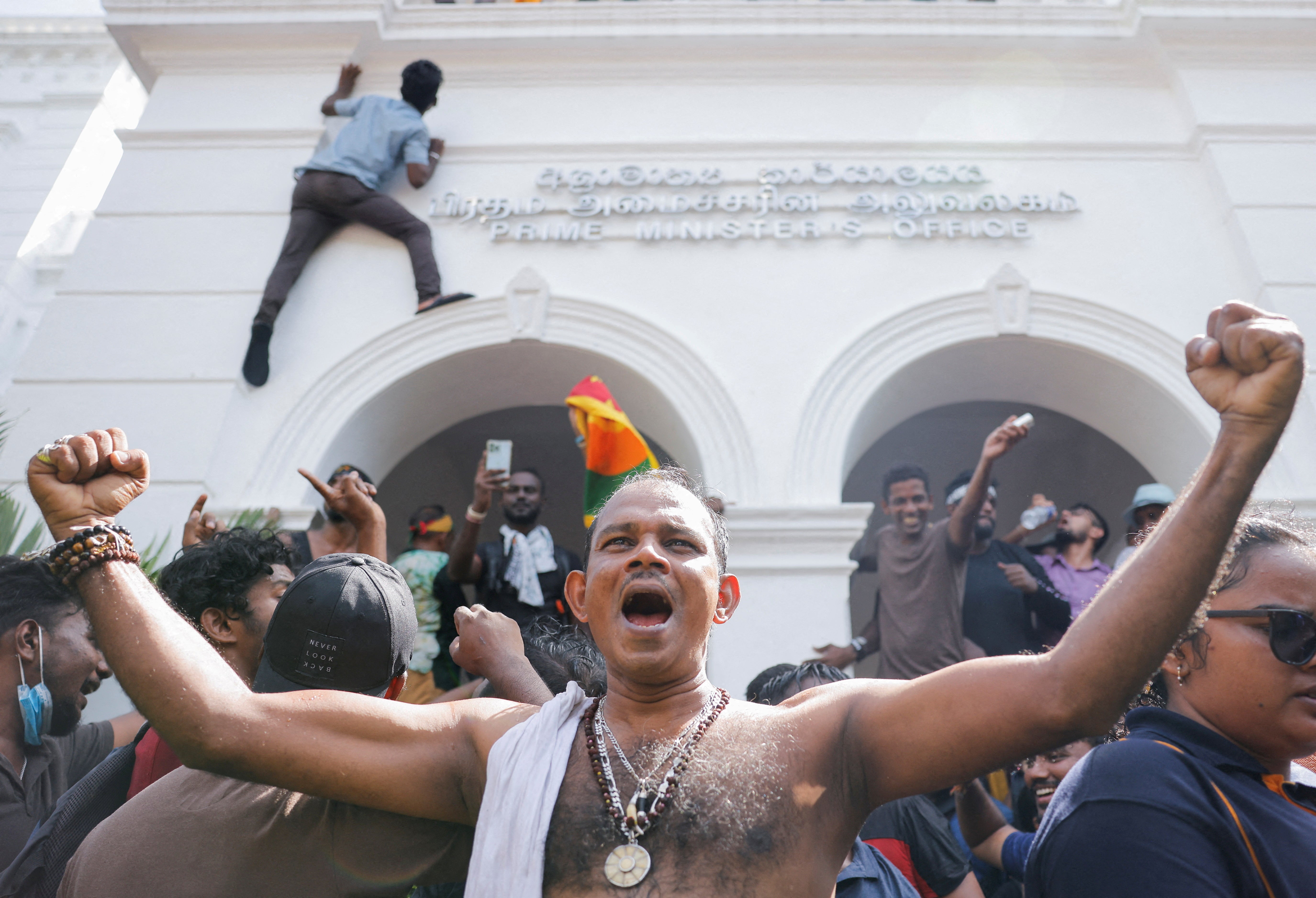 Demonstrators celebrate after they entered into Sri Lankan Prime Minister Ranil Wickremasinghe's office during a protest demanding for his resignation