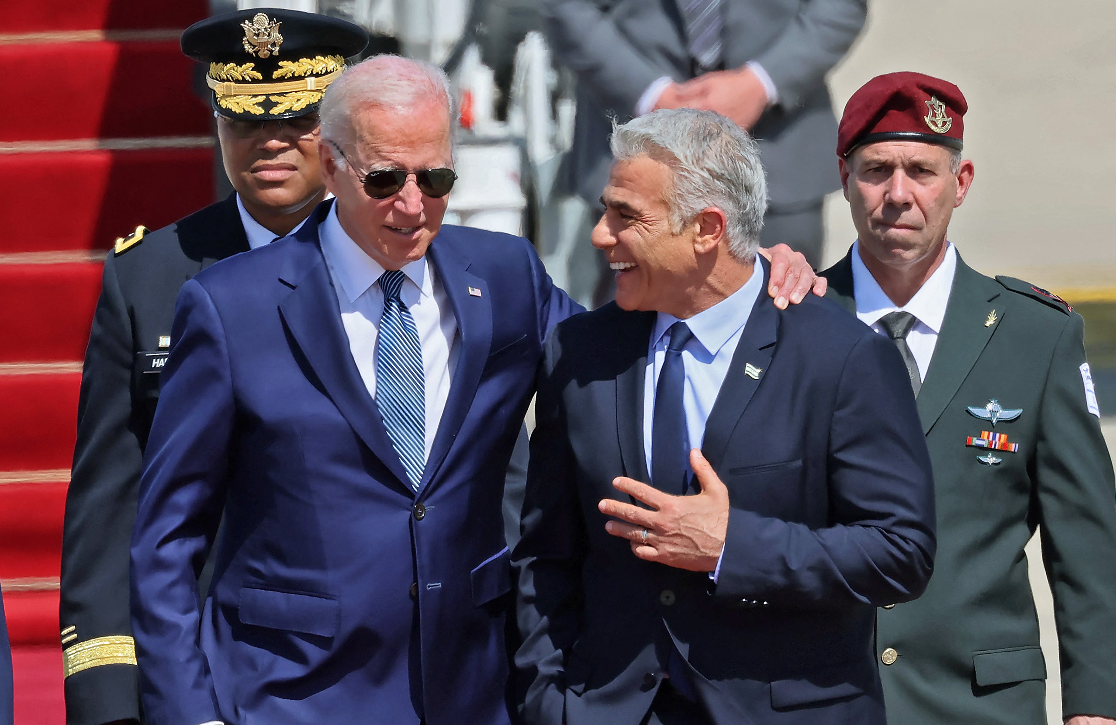 President Joe Biden is welcomed by Israeli caretaker Prime Minister Yair Lapid upon his arrival at Ben Gurion Airport in Lod near Tel Aviv