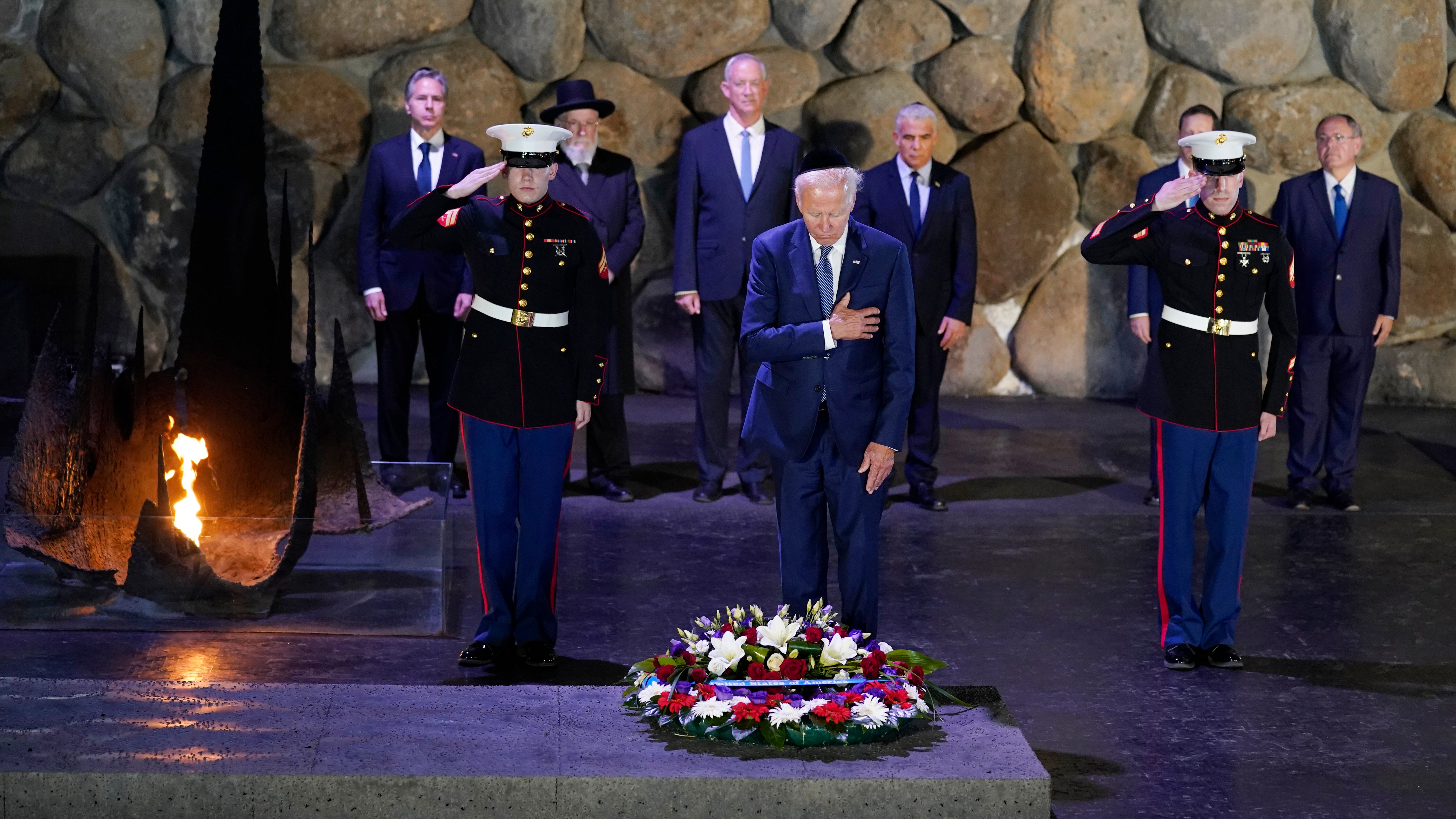 President Joe Biden, wearing a skullcap, participates in a wreath laying ceremony in the Hall of Remembrance at Yad Vashem