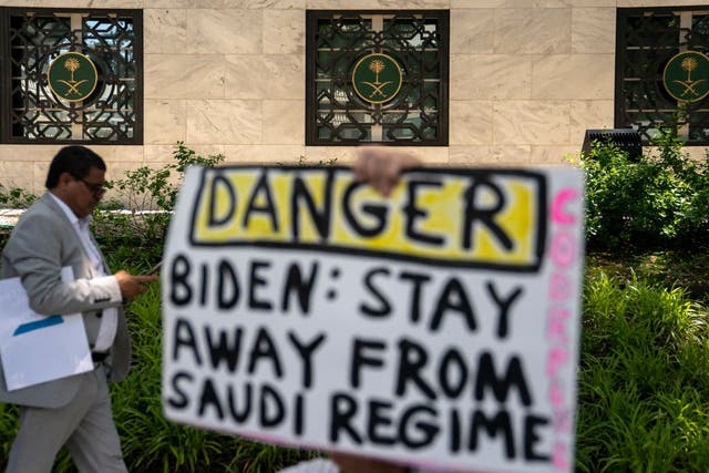 <p>A protester holds a signs outside of the Saudi embassy in Washington, DC</p>