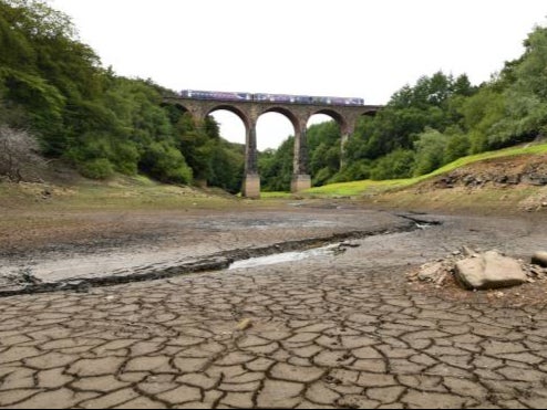 A parched section of the Wayoh Reservoir spanned by the Armsgrove Viaduct at Edgworth near Bolton, northwest England