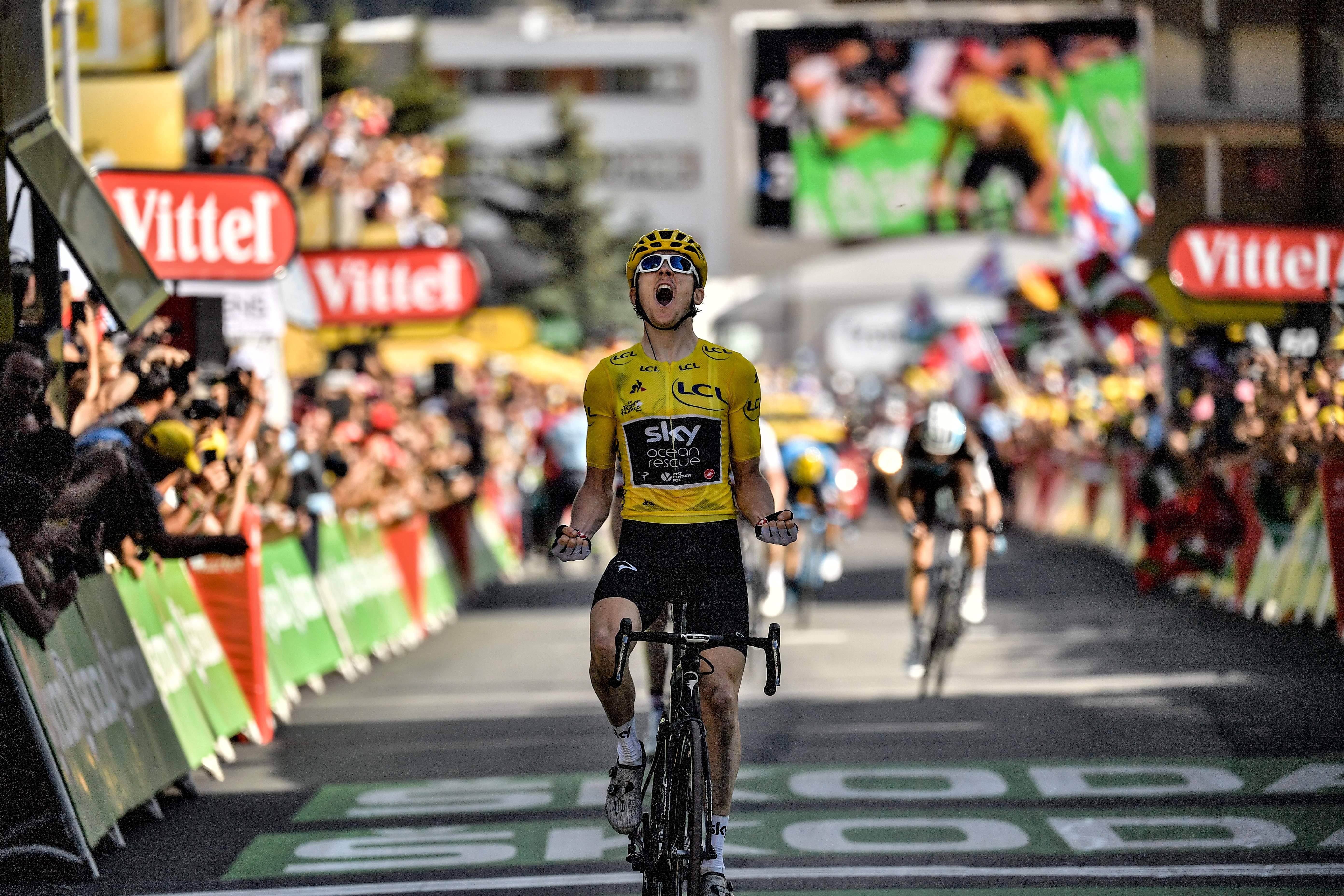Geraint Thomas celebrates as he crosses the finish line in 2018