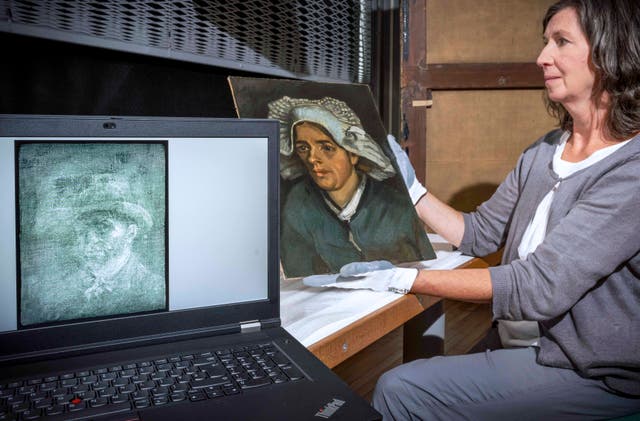 Senior paintings conservator Lesley Stevenson views Head of a Peasant Woman alongside an x-ray image of the hidden Van Gogh self-portrait (Neil Hanna/National Galleries of Scotland)