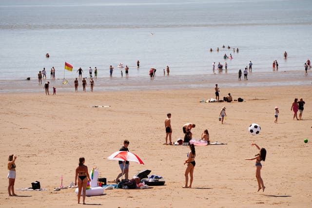 <p>People on the beach at Barry Island in the heatwave</p>