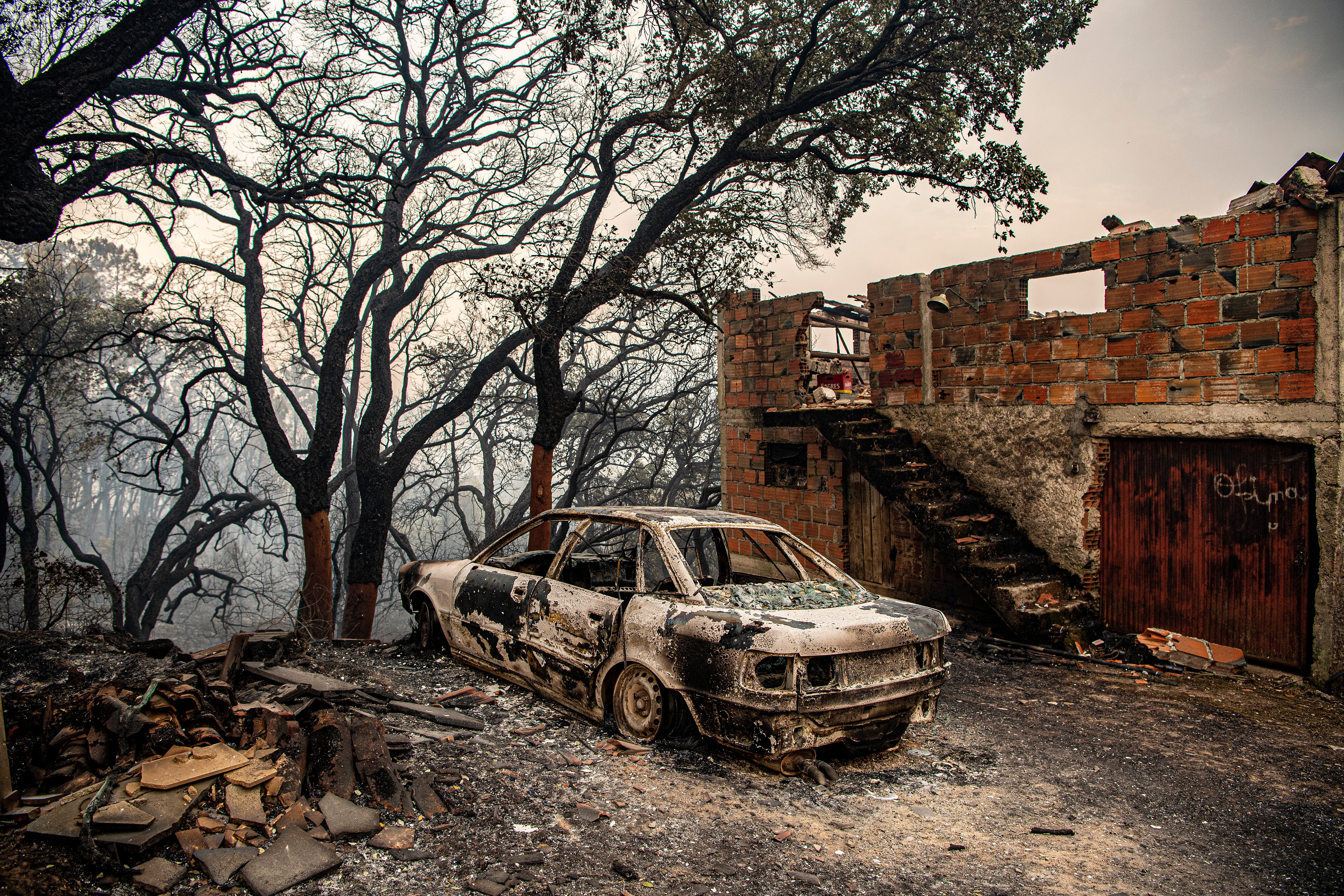 This photograph shows a car and burnt house at Ansiao in Pombal, Portugal