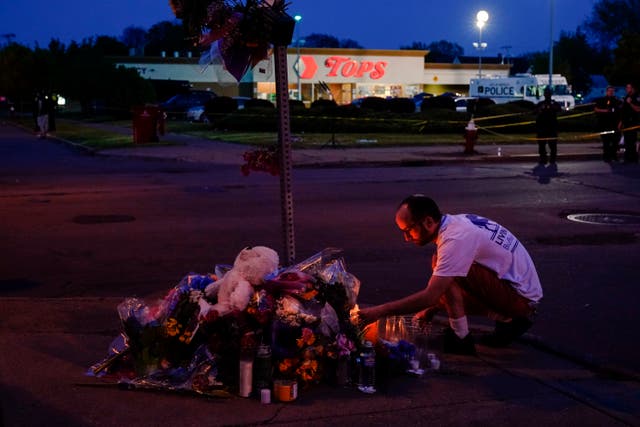 <p>People at a memorial outside of the market in Buffalo, New York </p>