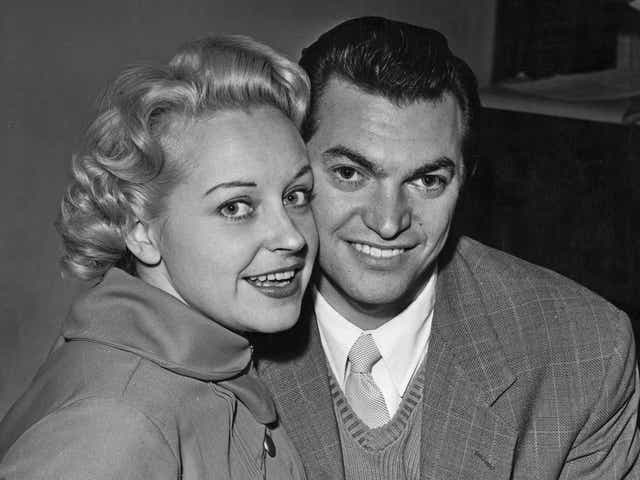 <p>Monty Norman and the actor and singer Diana Coupland announce their engagement in November 1955</p>