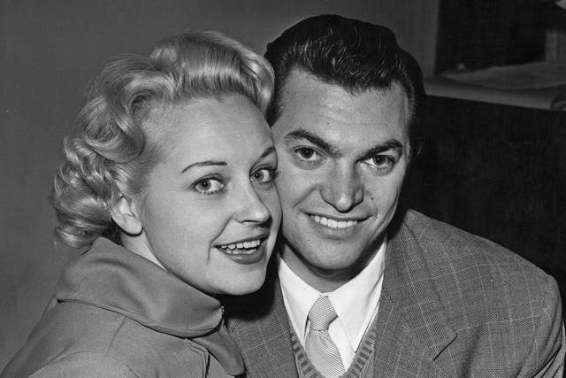 <p>Monty Norman and the actor and singer Diana Coupland announce their engagement in November 1955</p>