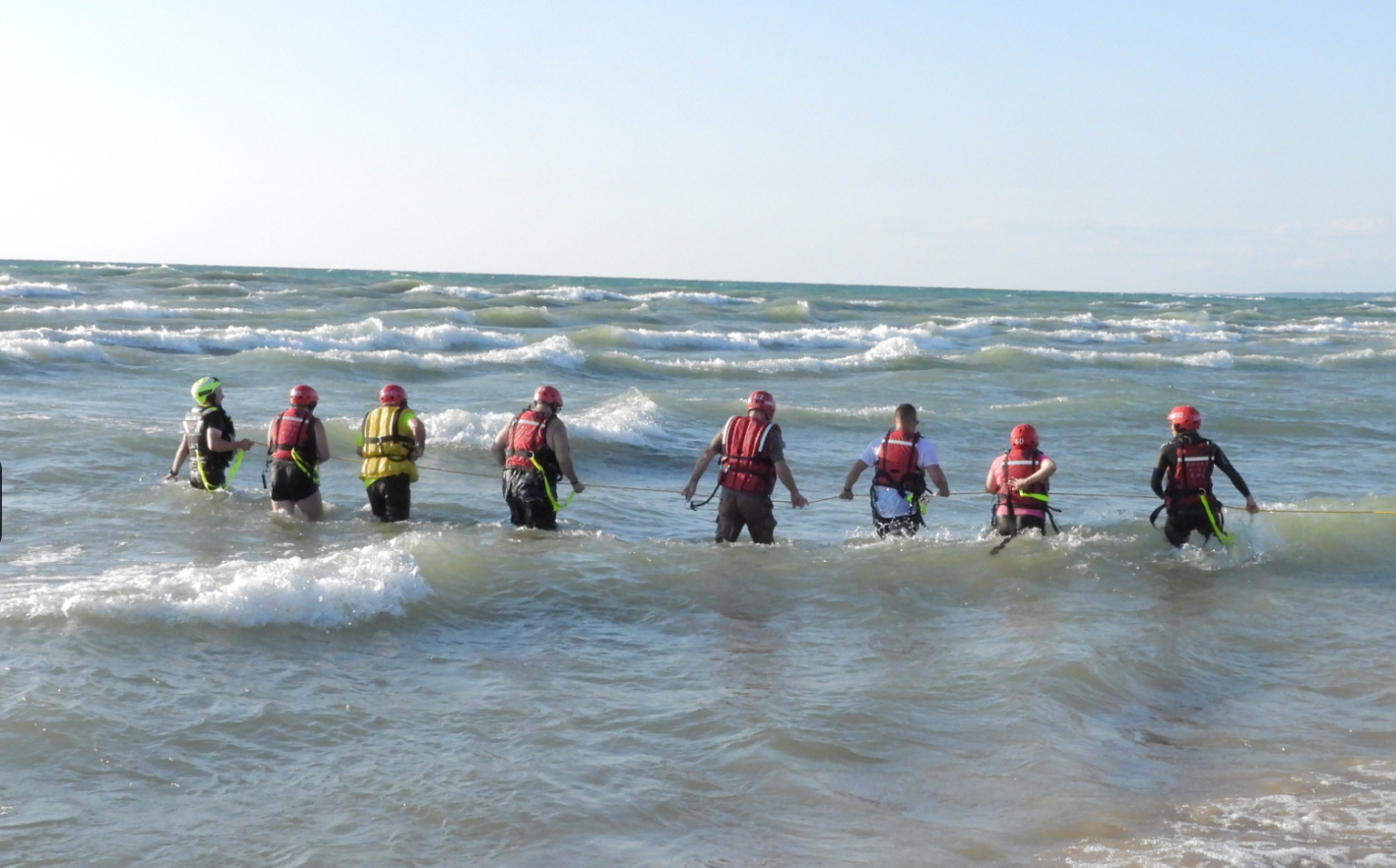 Emergency responders search the water at North Beach on Lake Michigan