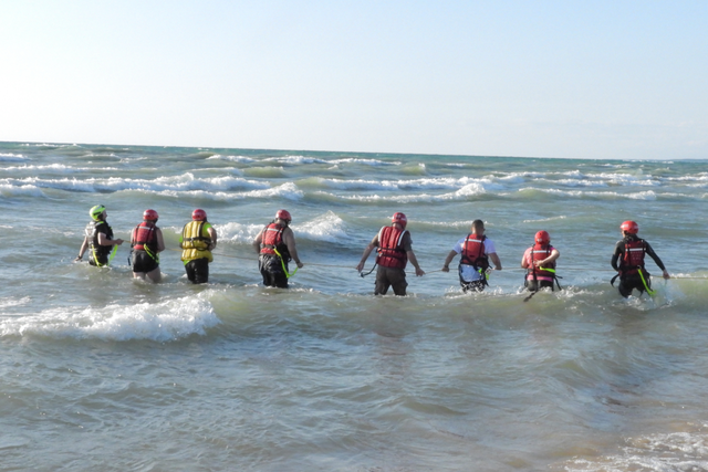 <p>Emergency responders search the water at North Beach on Lake Michigan</p>
