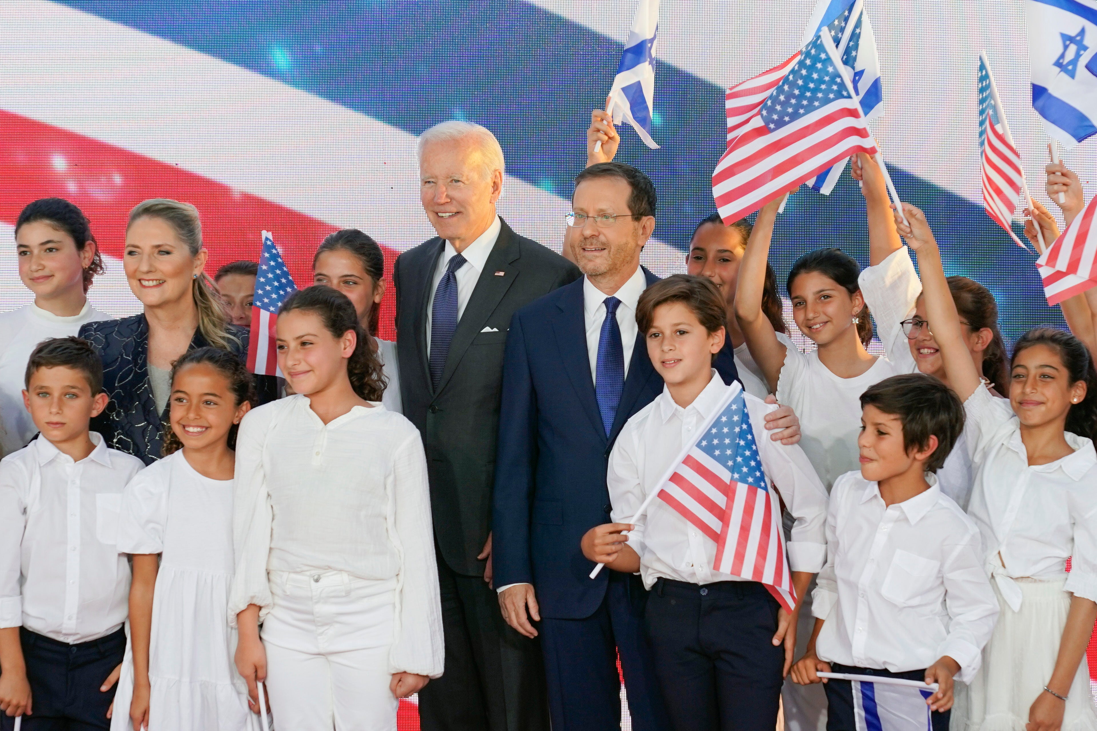 President Joe Biden stands with Israeli President Isaac Herzog and his wife Michal as they pose for photos with children