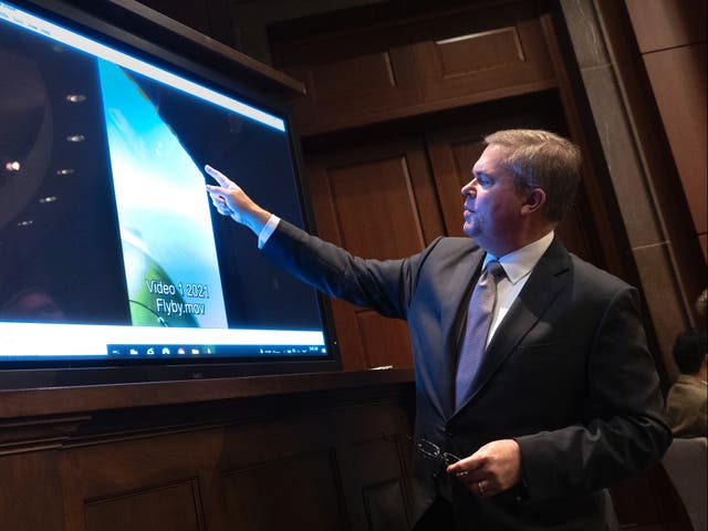 <p>US Deputy Director of Naval Intelligence Scott Bray explains a video of an unidentified aerial phenomena during a committee hearing in May 2022 </p>
