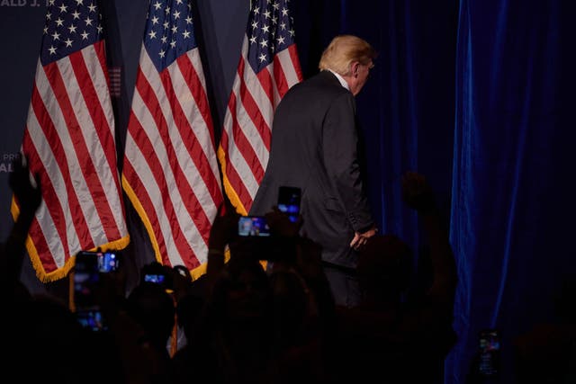 <p>Donald Trump departs the stage after an event in Las Vegas</p>