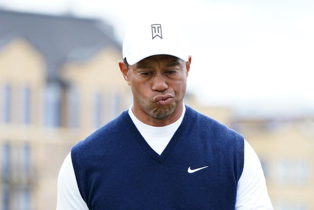 <p>Tiger Woods looks frustrated as he makes his way to the second tee after a double bogey on the 1st</p>